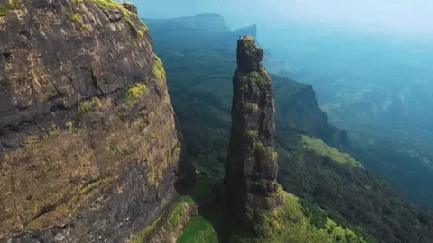 Drone View of Green Mountain Ridge Facing a Tall Peak with Scenic Sky Stock Footage 287750944