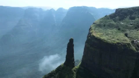 Drone View of Green Mountain Ridge Facing a Tall Peak with Scenic Sky Stock Footage 287751155