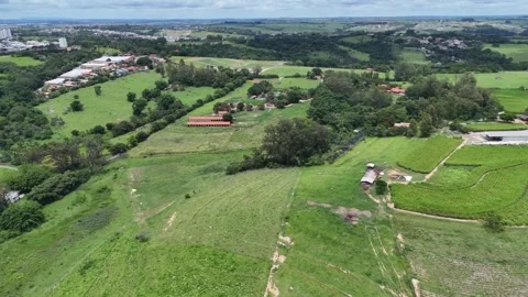 Drone View of Green Pastures and Rural Community Stock Footage 325810603