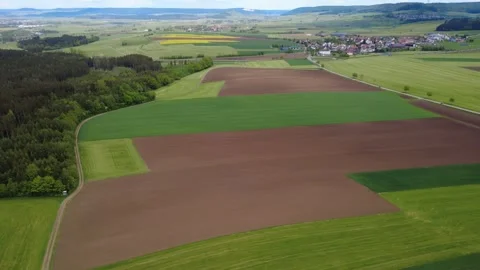Drone view of green spring fields and rural village on a sunny day. Stock Footage 336678178