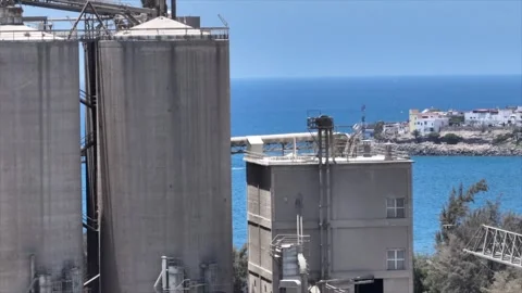 Drone View of Grey Old Factory with Scenic Coastal Backdrop, Arguineguín Stock Footage 310143252