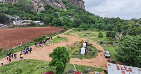 A drone view of group of people exploring or trekking mountains surrounded .. Video stock 325948652