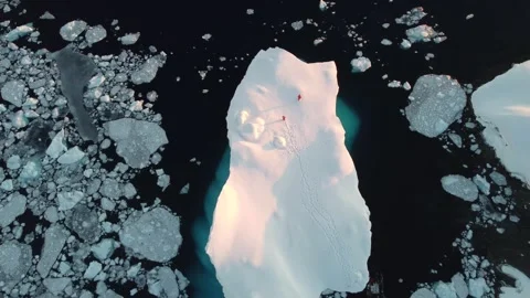 Drone view of a group of people standing on a large iceberg in Antarctica 스톡 동영상 321611192