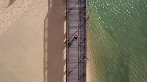 Drone view of a guy walking on a wooden bridge Vídeos de archivo 246386914