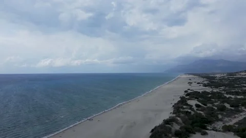 Drone view from a height of a long sandy beach, sea, clouds, sandy mountains Stock Footage 169087488