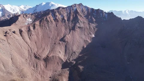 Drone view of high snow peaks and steep cliffs Stock Footage 213002917