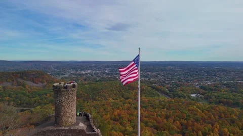 Drone view of a historic stone tower and American flag above... Stock Footage 319883900
