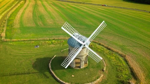 Drone view of historic stone windmill with white sails among farmland Stock Footage 346811703