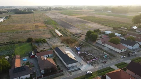 Drone view of house plot during early morning foundation phase construction Vídeos de archivo 310550005