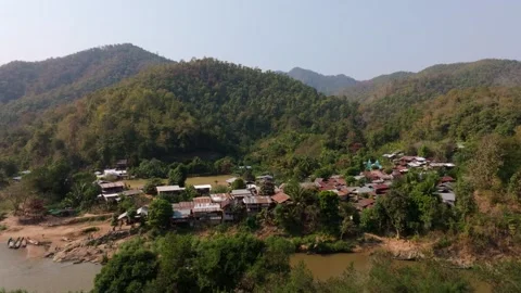 Drone view of Huay Pu Keng village and river in forested hills, Thailand Stock Footage 309145833