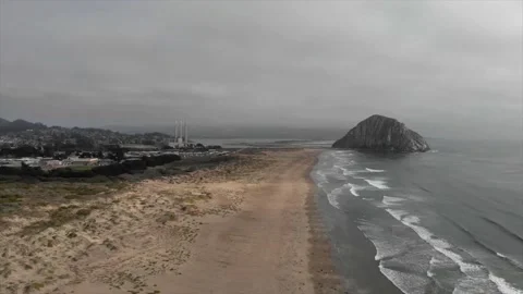 Drone view on  huge rock in  ocean on cloudy day Stock Footage 241362530
