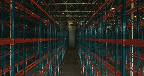 Drone view inside warehouse. Rows of metallic frameworks. Camera going down. Sun Stock Footage 135514037