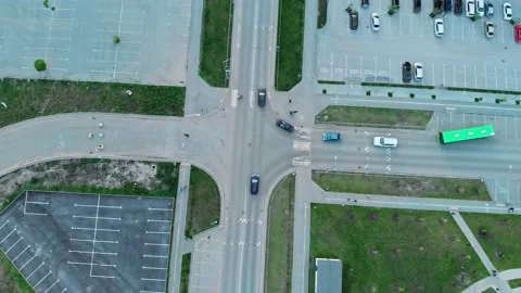 Drone view of an intersection with footpaths that cross the roadway, car drivers Stock Footage 202303065