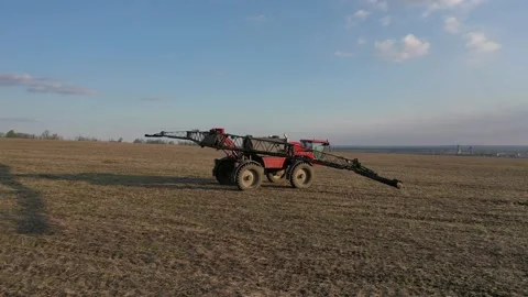 Drone view of an irrigation machine folding its extensions in the field, sunset Stock Footage 161026177