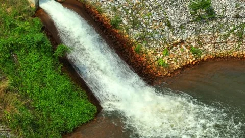Drone view of irrigation water cascading into a pond. Video stock 331279778