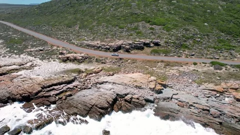 Drone view Isolated Coast Drive. Footage Of Solitary Car Along Rocky Coastal Vidéo 339764936