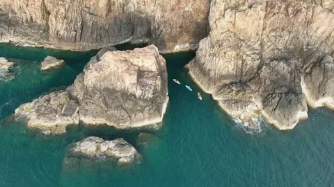 Drone view of kayaks between sea cliffs at Eo Gio, Quy Nhon Stock Footage 337891690