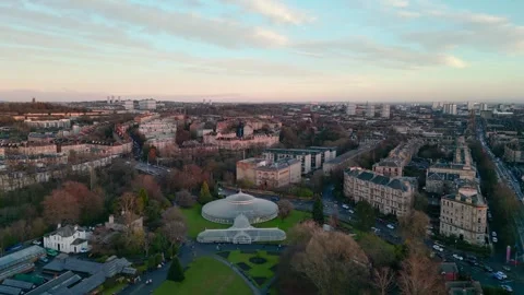Drone View: Kibble Palace Glasgow Botanic Gardens to Dusk City Skyline Stock Footage 263492598