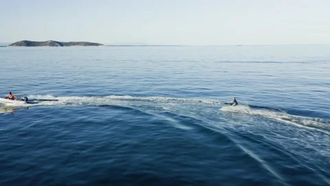 Drone view of kid doing water ski in the sea. Video stock 158953571