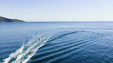 Drone view of kid doing water ski in the sea. Stock Footage 158954355