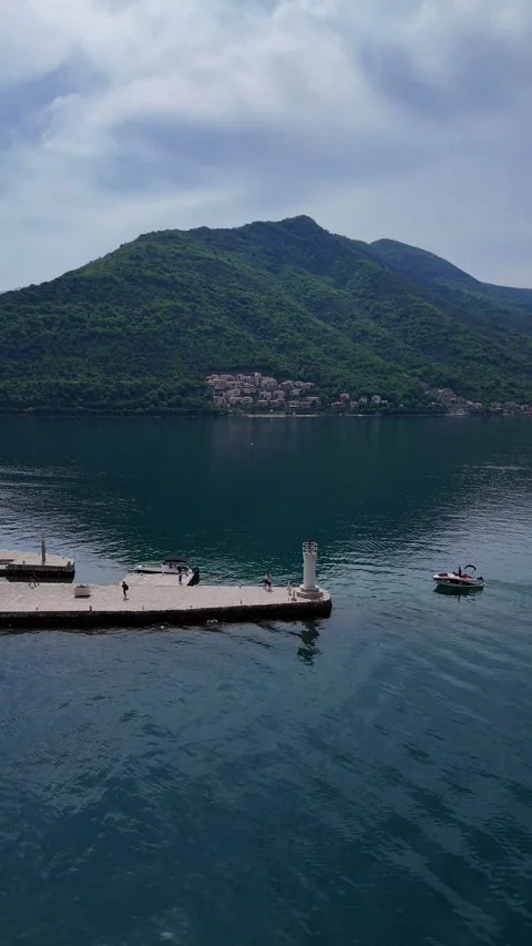 Drone View of Kotor Bay, Lighthouse, Boats, and Majestic Mountains. Stock Footage 300845217