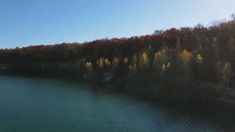 Drone View on lake with clear turquoise water and beautiful autumn forest Stock Footage 164690176