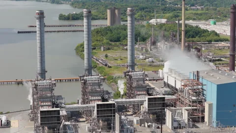 Drone view of a large energy power station beside a wide river Stock Footage 346380901