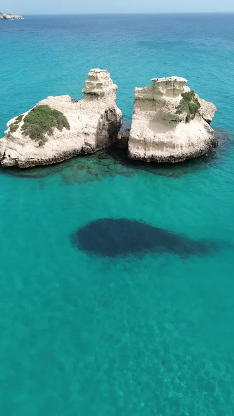 Drone view of Le Due Sorelle sea stacks, Torre dell`Orso, Italy Stock Footage 317904601
