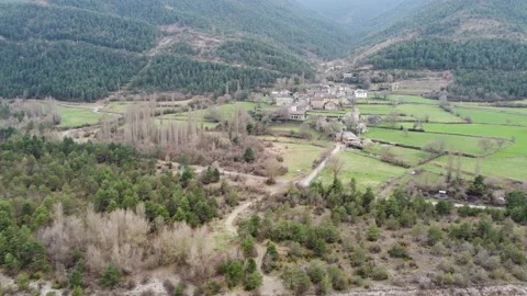 Drone view of Ligerre de Ara town between forests and pasture meadows Stock Footage 174376083