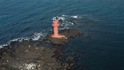 Drone view. A lighthouse standing in the middle of the sea like an island. Jeju  Stock Footage 122271223