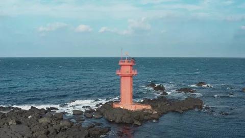 Drone view. A lighthouse standing in the middle of the sea like an island. Jeju  Stock Footage 122271303