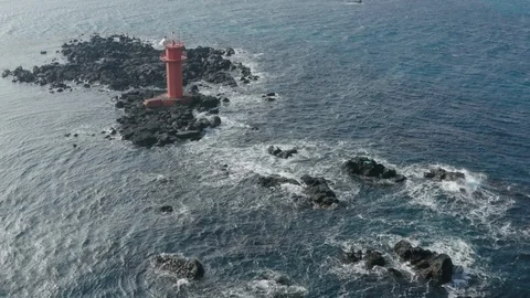 Drone view. A lighthouse standing in the middle of the sea like an island. Jeju  Stock Footage 122272230