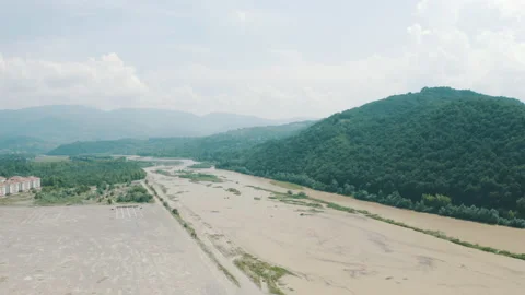 Drone view of the lighthouse in the trees, the white lighthouse building built Stock Footage 234098597