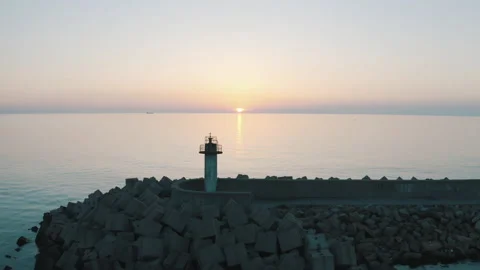 Drone view of the lighthouse in the trees, the white lighthouse building built Stock Footage 234098715