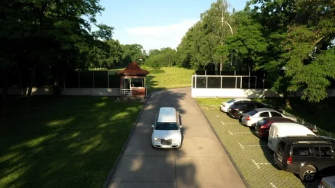 Drone view A limousine is driving; the camera moves backward Stock Footage 111874293