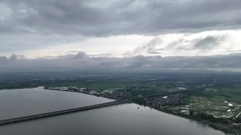 Drone view of long bridge and blue lake under dramatic sky in China Stock Footage 337754385