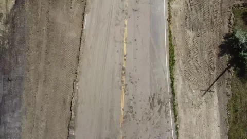 Drone view looking directly down of a paved road construction project Stock Footage 248918104