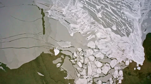 Drone view looking downward at fractured ice sheets on the surface of the Great Stock Footage 337720969