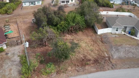 Drone View of Lot Clearing Amid Residential Structures Stock-Footage 334012412
