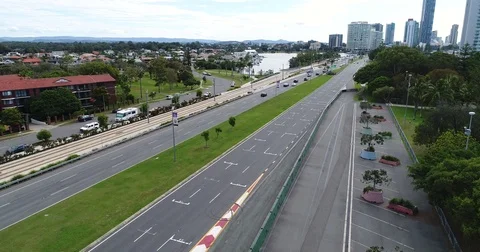 Drone view lowering with traffic and Surfers Paradise Racing Track Stock Footage 76037146