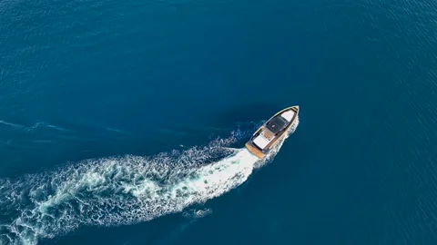 Drone view of a  Luxury boat the blue clear waters. Top view of a fast movement Stock Footage 207494518