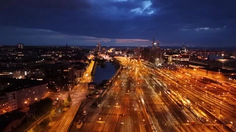 Drone view of Malmö’s glowing train lines flowing into central station Stock Footage 339796295