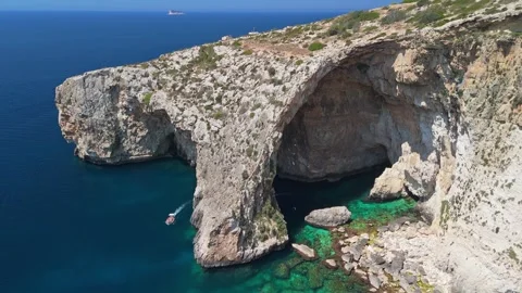 Drone view of Malta's Blue Grotto sea arch and cliffs above azure water Stock Footage 337000775