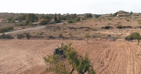 Drone View Of A Man On A Farm Tractor Plowing A Country Field Stock Footage 97710205