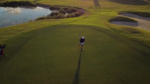 Drone view of a man playing on a golf club course. Circular motion around t.. Video stock 252603855