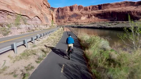Drone View Man Riding E-Bike Through Sandstone Canyon Trail Near Moab, Utah Stock Footage 339002732