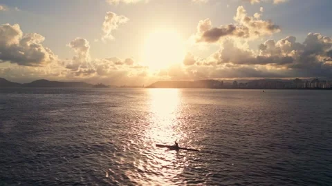 Drone view of a man sailing on a canoe at sunset. Stock Footage 246818867