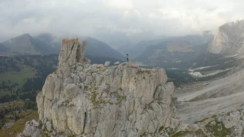 Drone view of man standing on mountain ridge in 4k. Stock Footage 143371689