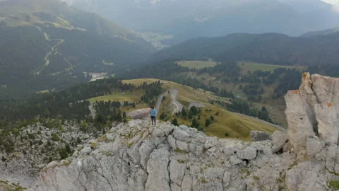 Drone view of man standing on mountain ridge in 4k. Stock Footage 143371807