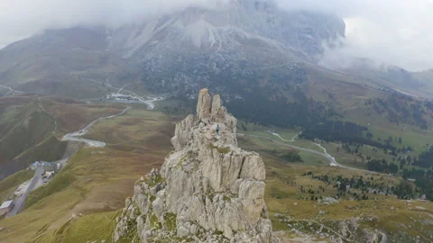 Drone view of man standing on mountain ridge in 4k. Stock Footage 143373884